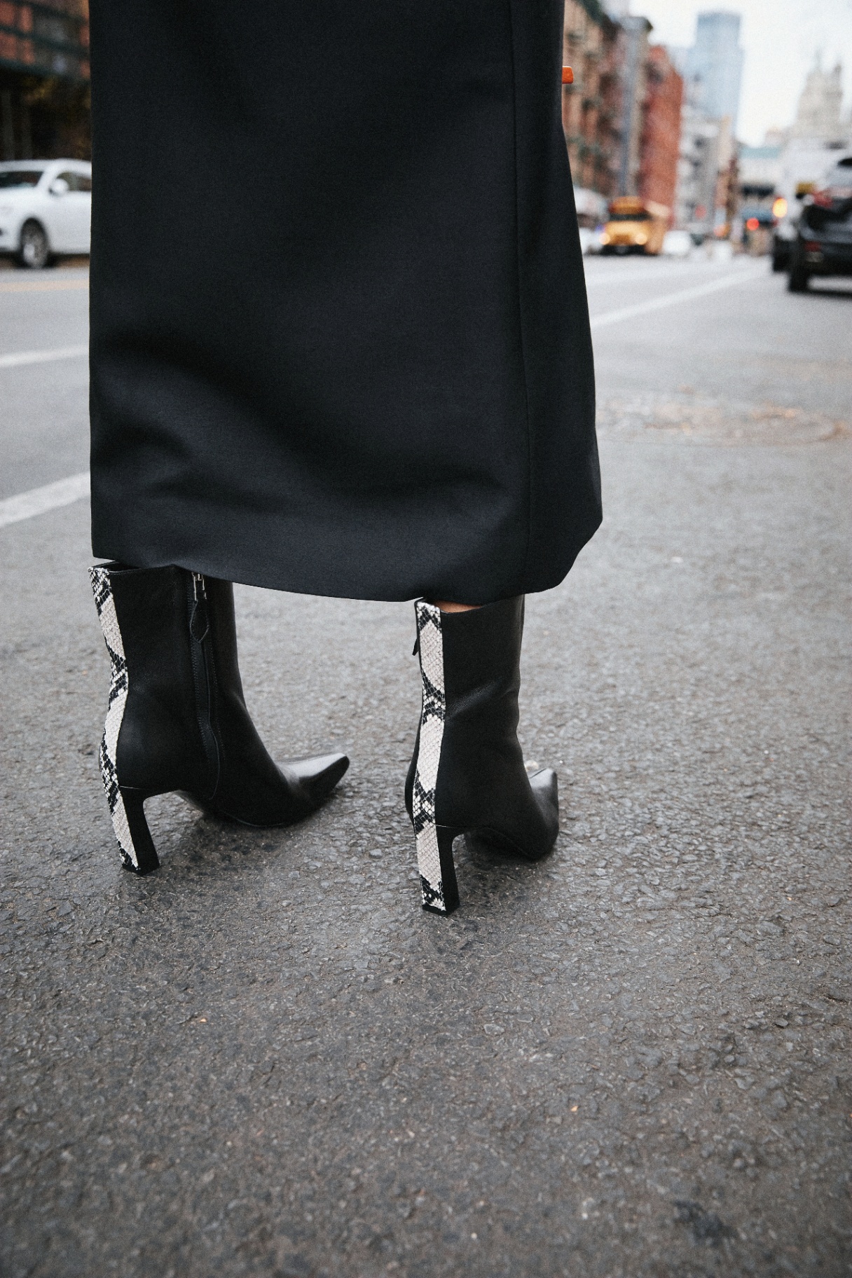 THE L—INE — black dress with pointed heeled boots on the street